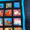 Detailansicht der bunten Katzen vom aufwändig gearbeiteten Quilt in Übergröße. Stoff-Unikat handmade in Germany