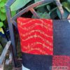 Detailansicht vom Motivkissen mit Musikinstrumenten und Noten in schwarz-weiß-rot. Stoff-unikat handmade in Germany